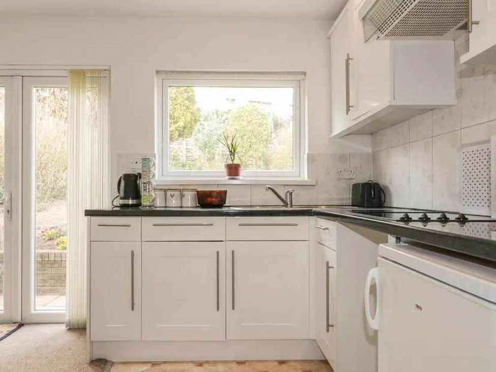 A kitchen with sink and stove at Bungalow Sleeps 2 Parking in Newquay