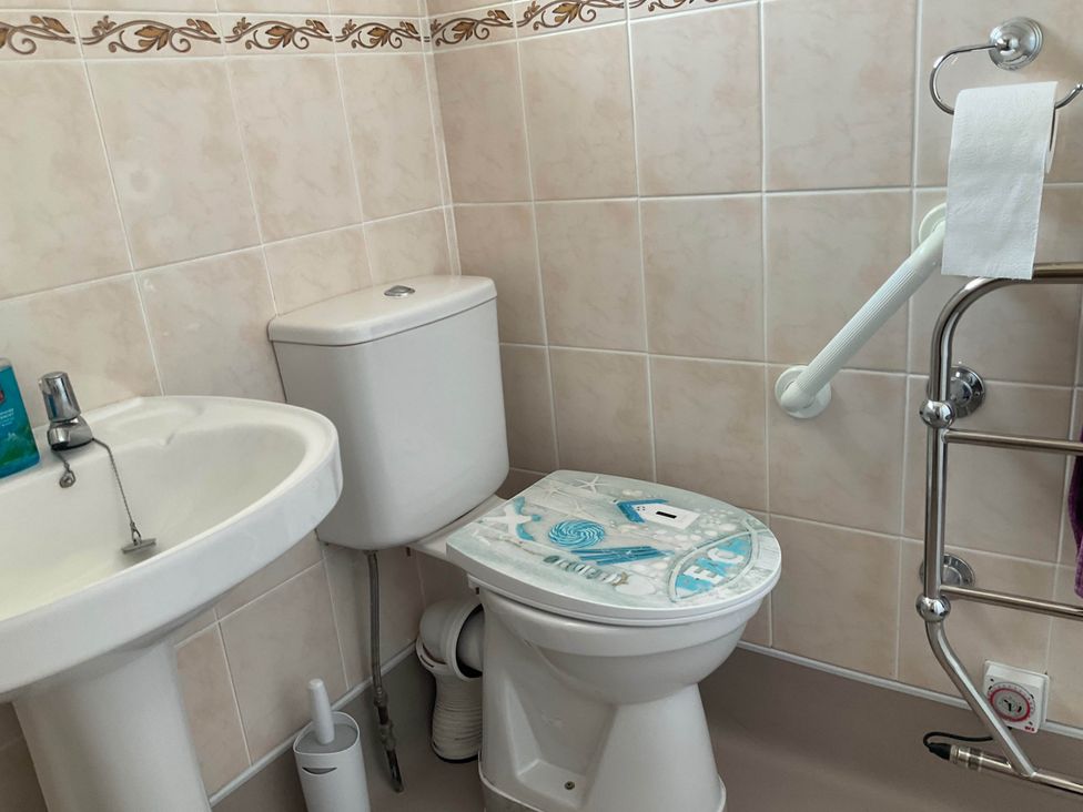 A bathroom with a sink and toilet at Bungalow Sleeps 2 Parking Newquay