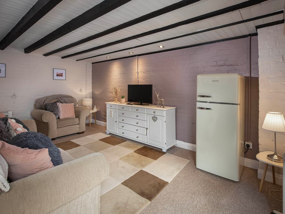 A living room with sofa and fridge at Cottage Sleeps4  PetFriendly  Garden  ByBeach Lytham St Annes