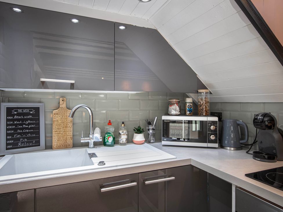 A kitchen with a sink and microwave at Cottage Sleeps4 PetFriendly Garden ByBeach Lytham St Annes