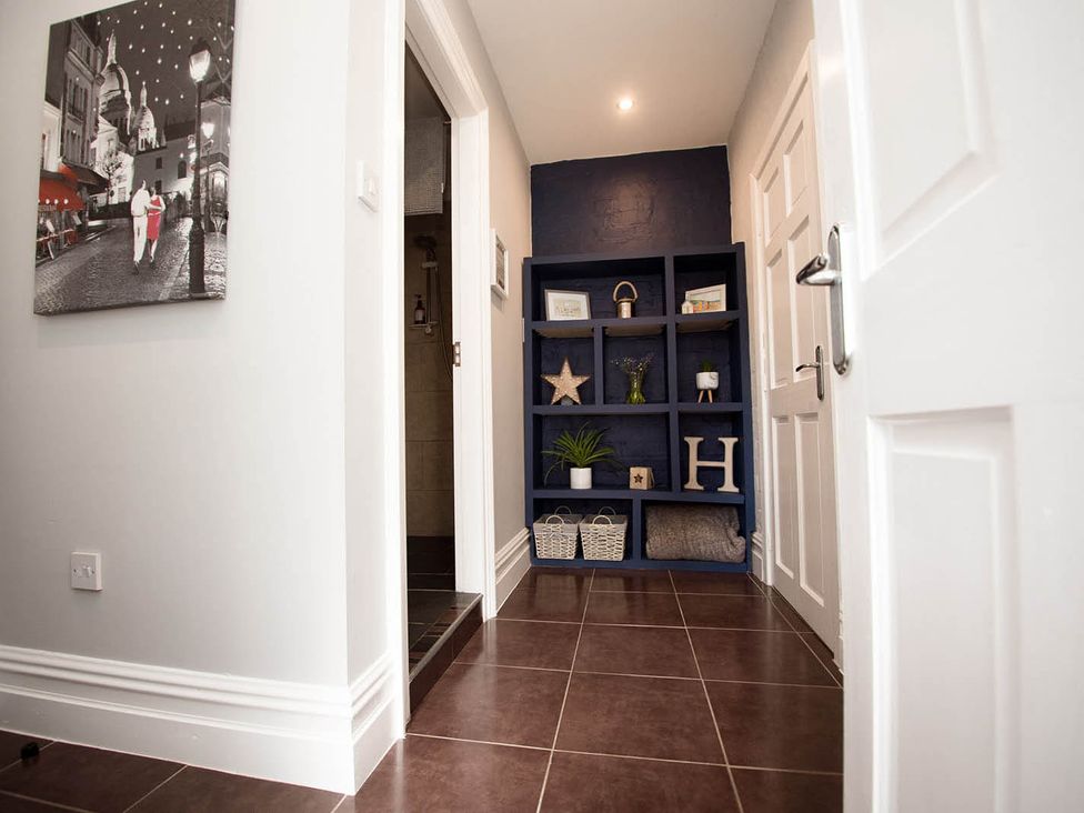 A hallway with a shelf and artwork at Cottage Sleeps4 PetFriendly Garden ByBeach in Lytham St Annes
