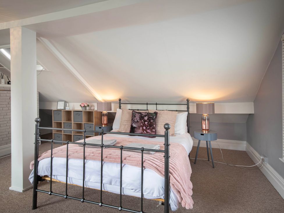 A bedroom with a bed and bedside tables at Cottage Sleeps4  PetFriendly  Garden  ByBeach in Lytham St Annes