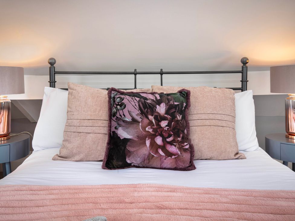 A bed with pillows and lamps in the bedroom at Cottage Sleeps4  PetFriendly  Garden  ByBeach Lytham St Annes