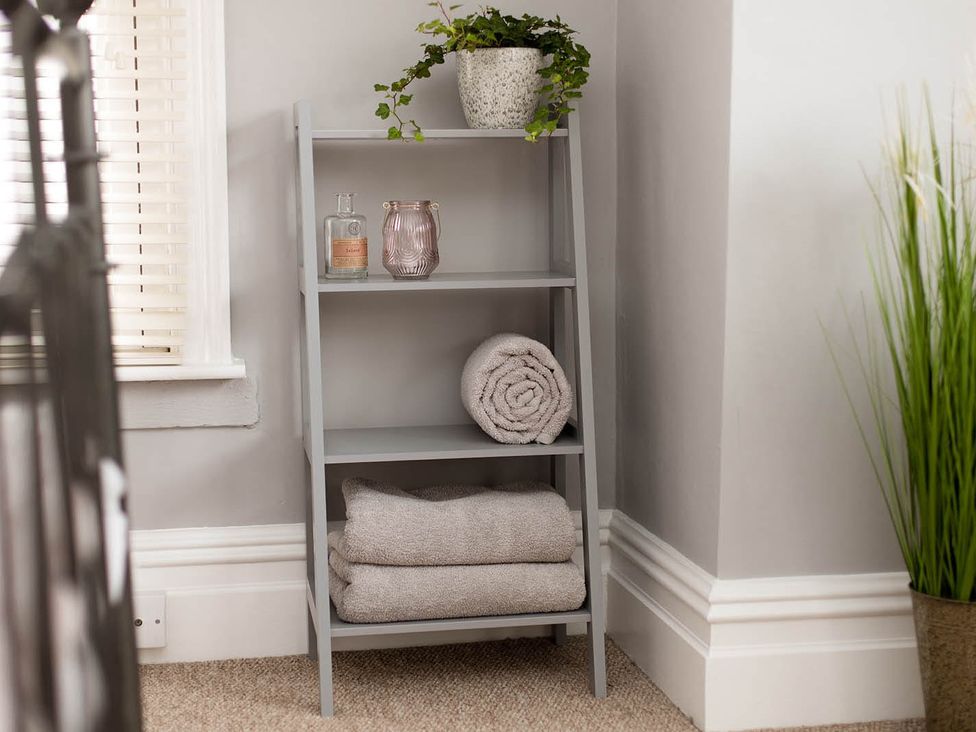 A shelf with towels and decorative items at Cottage Sleeps4 PetFriendly Garden ByBeach in Lytham St Annes