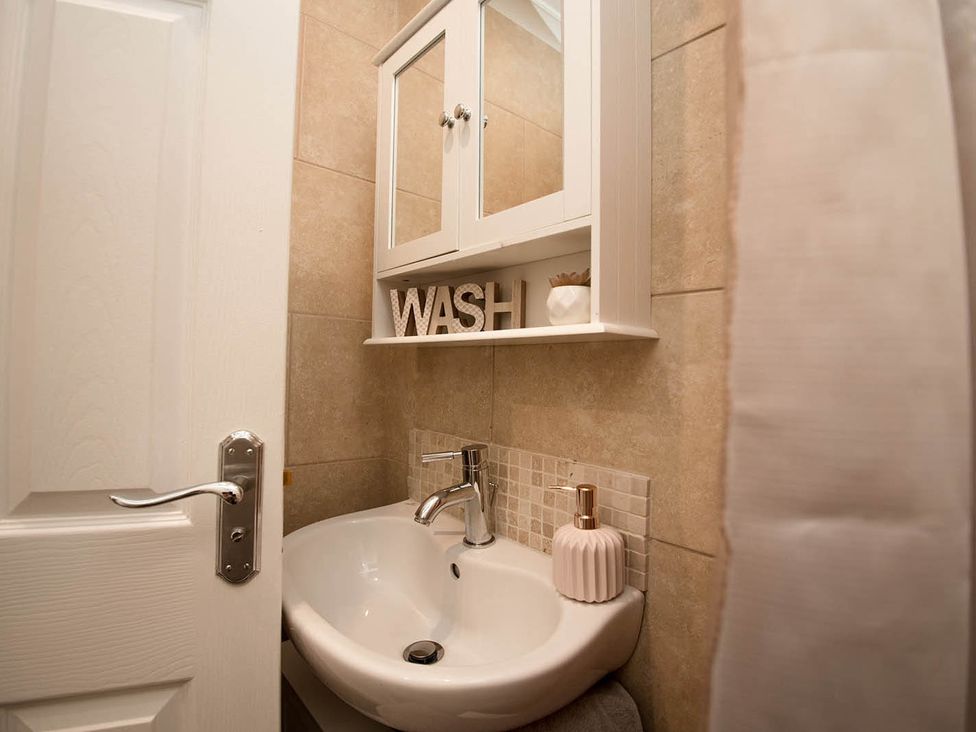 A bathroom with a sink and mirror at Cottage Sleeps4 PetFriendly Garden ByBeach Lytham St Annes