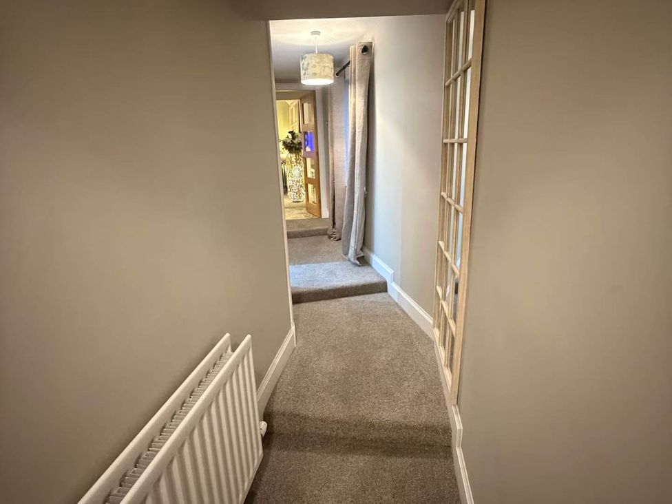 A hallway with carpet and a radiator at 2 Bed Cottage Sleeps 4 Parking Wifi Darnick