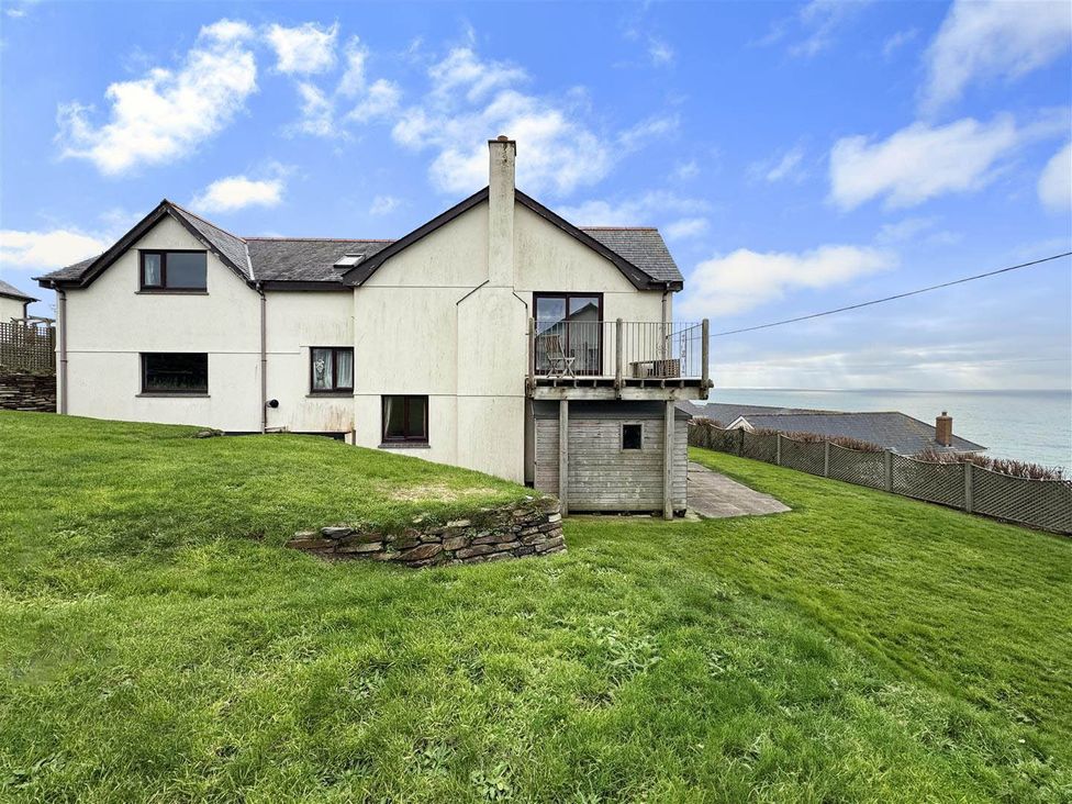 A house with a balcony and garden at Porthleven Coastal Retreat with 5 Bedrooms in Porthleven