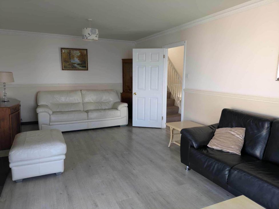 A living room with sofas and a staircase at Porthleven Coastal Retreat with 5 Bedrooms Porthleven