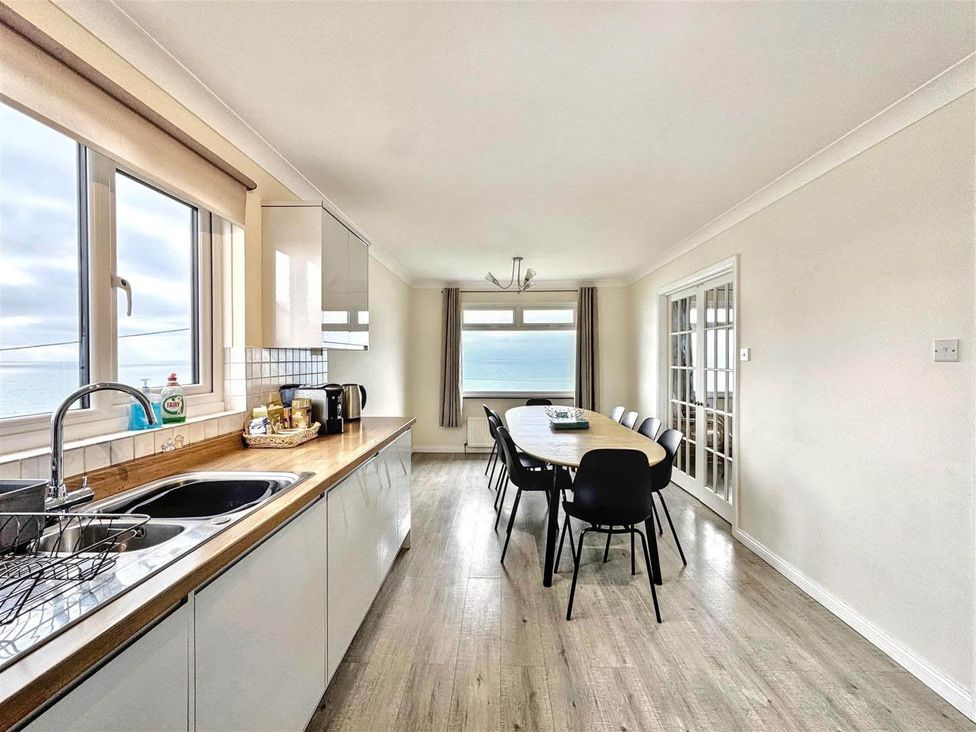 A kitchen with a dining table and chairs at Porthleven Coastal Retreat with 5 Bedrooms in Porthleven