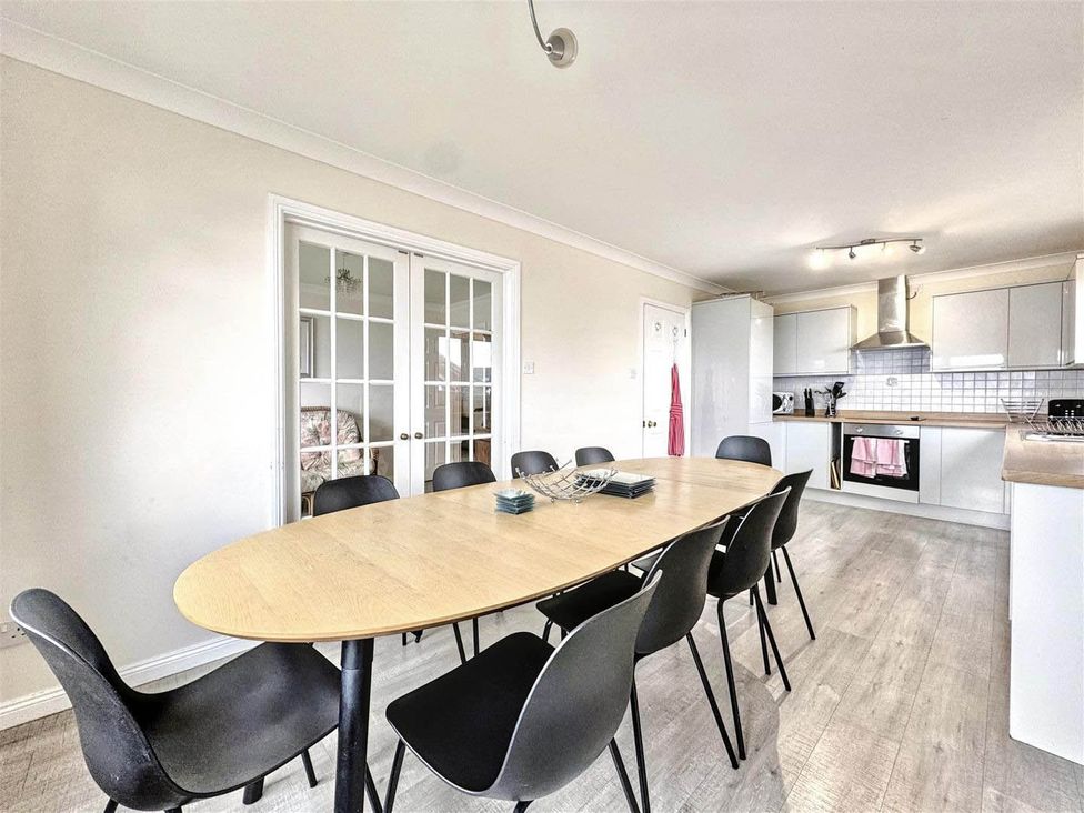 A dining room with a table and chairs at Porthleven Coastal Retreat with 5 Bedrooms in Porthleven