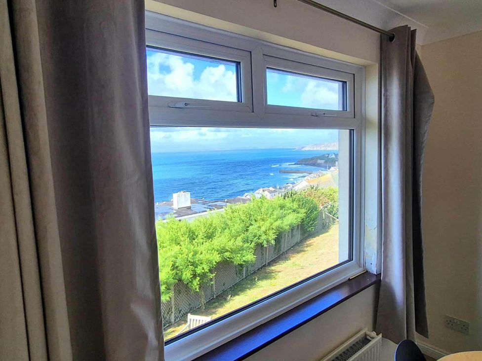 A living room with a view of the ocean at Porthleven Coastal Retreat with 5 Bedrooms in Porthleven
