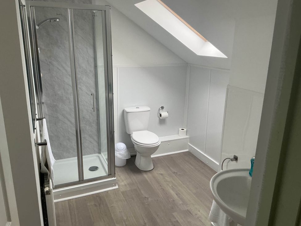 A bathroom with shower and toilet at Porthleven Coastal Retreat with 5 Bedrooms Porthleven