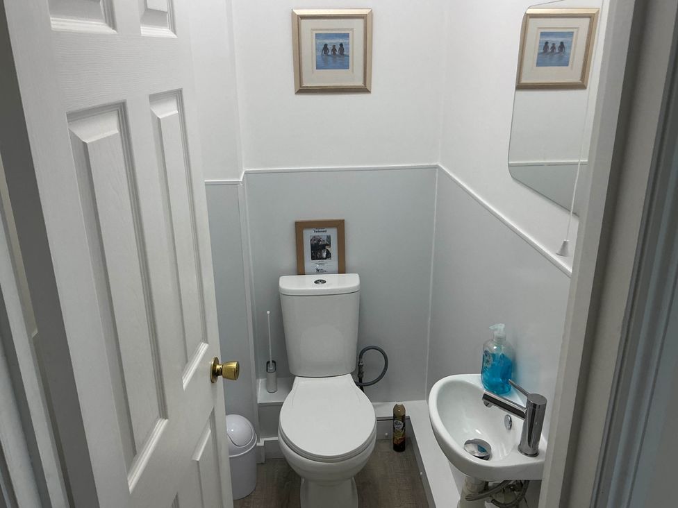 A bathroom with a toilet and sink at Porthleven Coastal Retreat with 5 Bedrooms Porthleven
