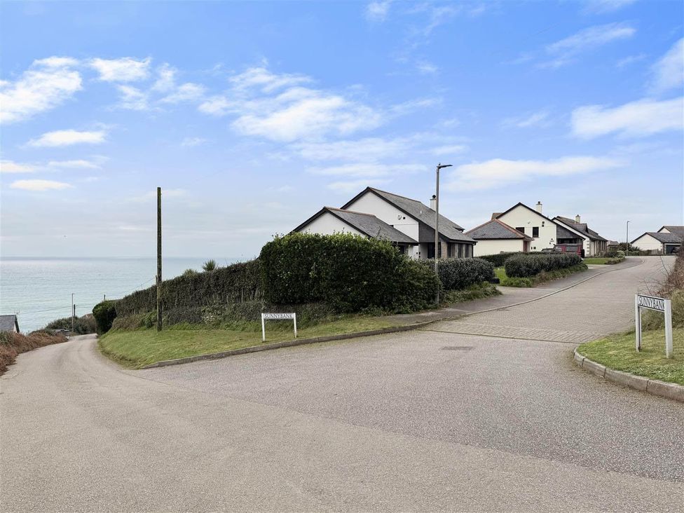 A view of houses and ocean along the road at Porthleven Coastal Retreat with 5 Bedrooms Porthleven