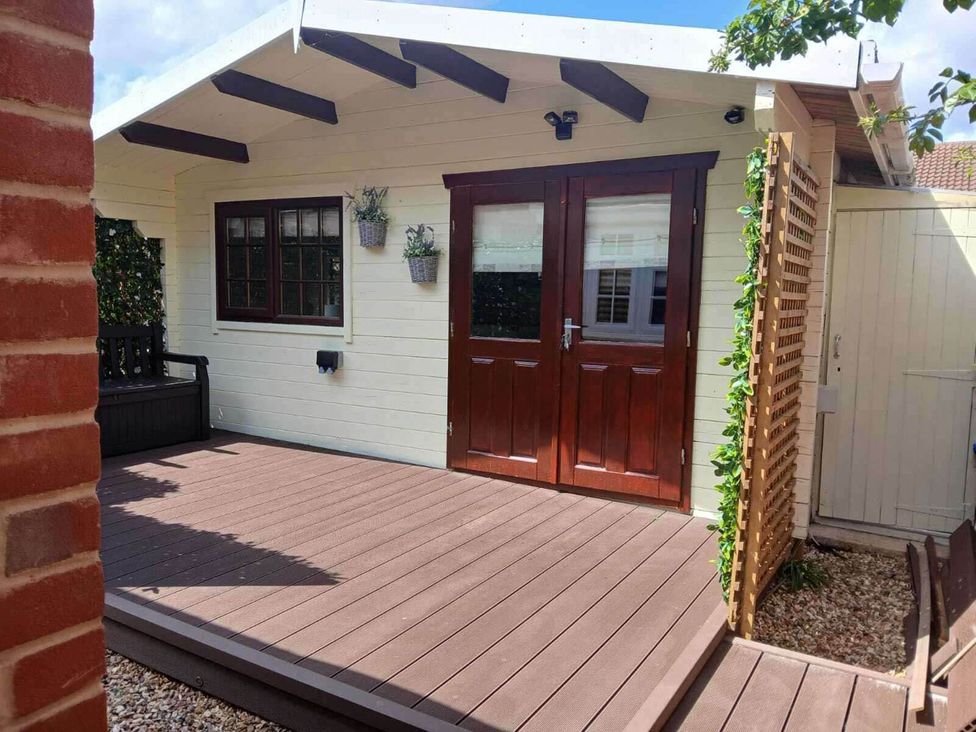 An outdoor area with wooden doors and decking at 1 Bed Lodge Southampton Sleeps 2 Parking Southampton