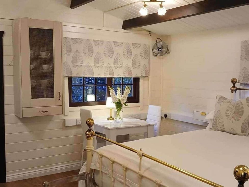 A bedroom with a bed and a table at 1 Bed Lodge Southampton Sleeps 2 Parking Southampton