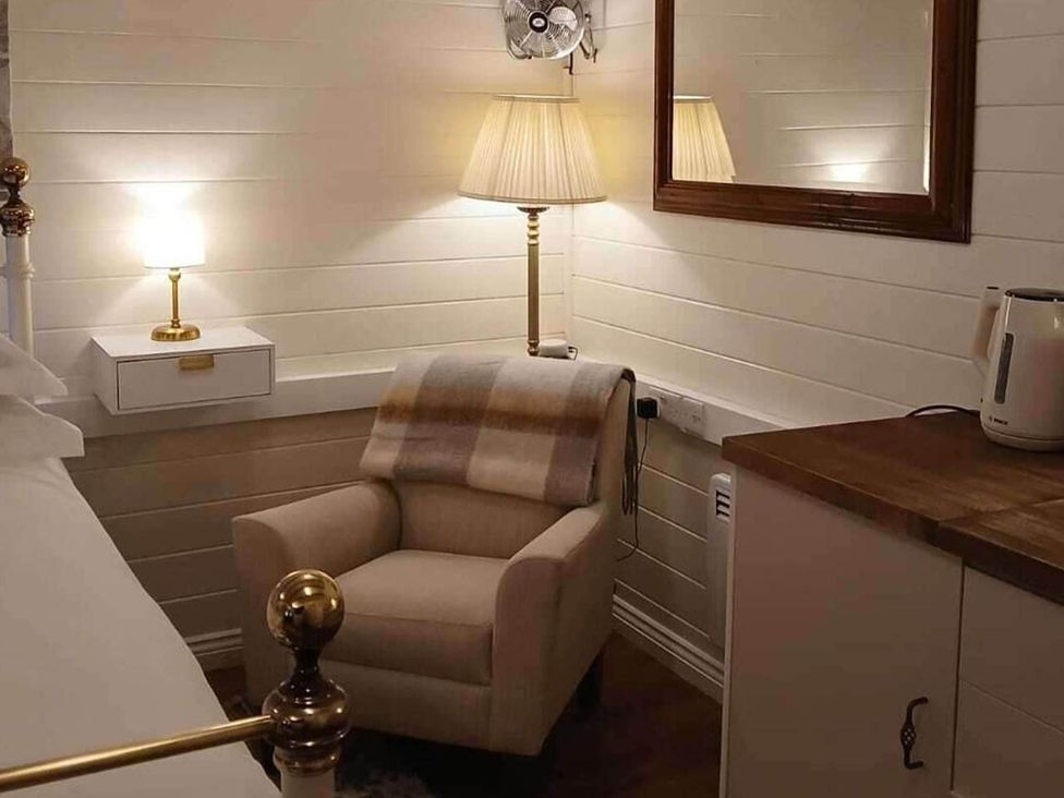 A bedroom with a chair and lamp at 1 Bed Lodge Southampton Sleeps 2 Parking Southampton