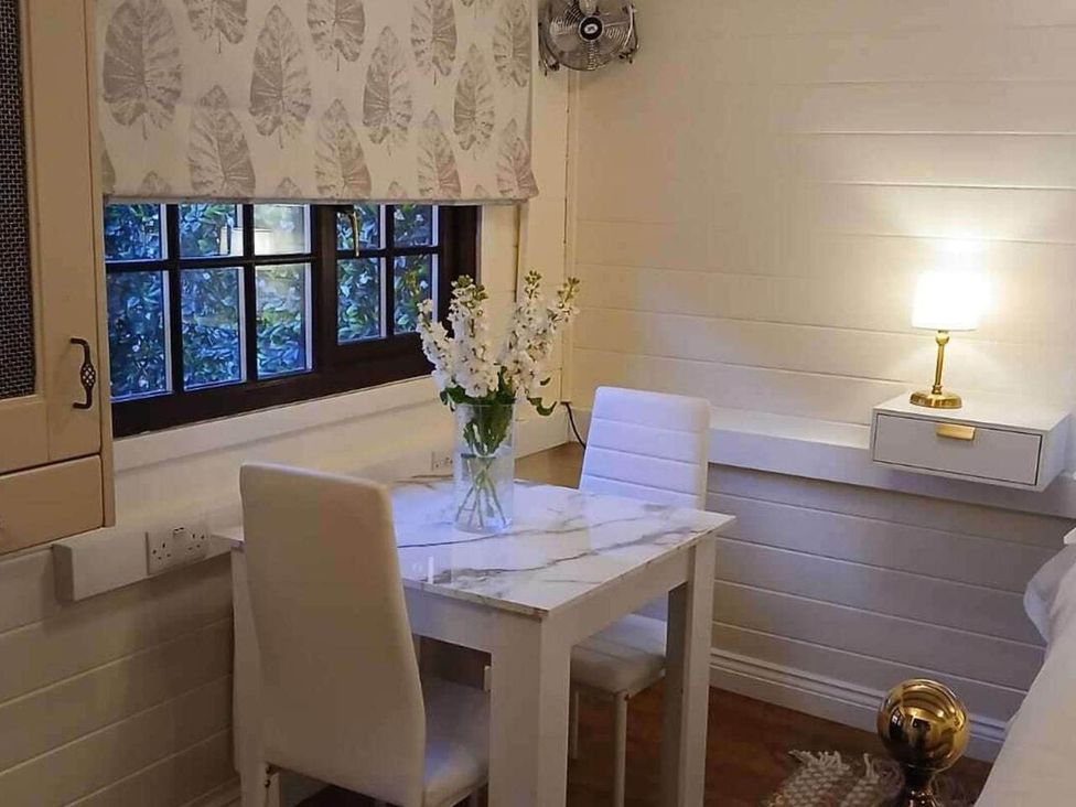 A dining area with a table and two chairs at 1 Bed Lodge Southampton Sleeps 2 Parking Southampton