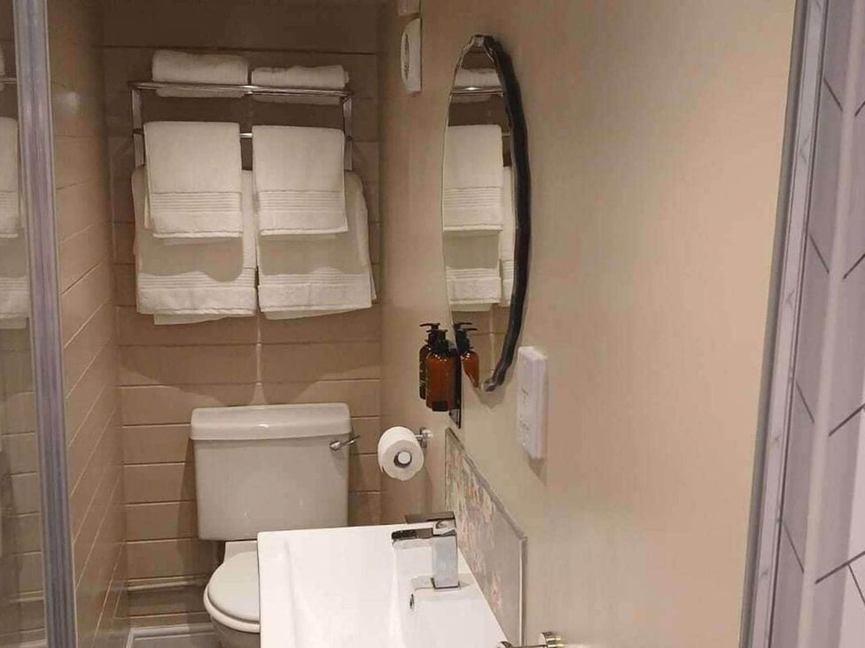A bathroom with a toilet, sink, and towels at 1 Bed Lodge Southampton Sleeps 2 Parking in Southampton