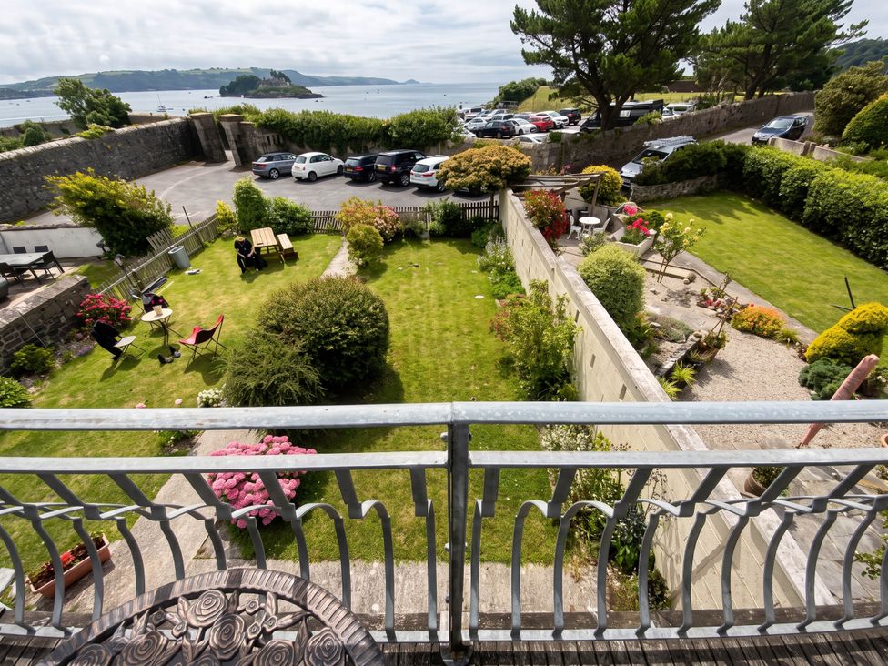 An outdoor area with a garden and parking lot at Beautiful Sea Front Cottage in Plymouth