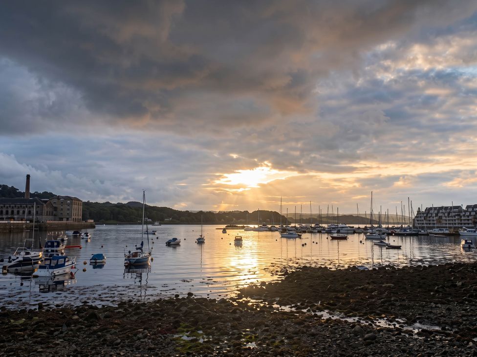 A view of boats on water during sunset at Beautiful Sea Front Cottage in Plymouth