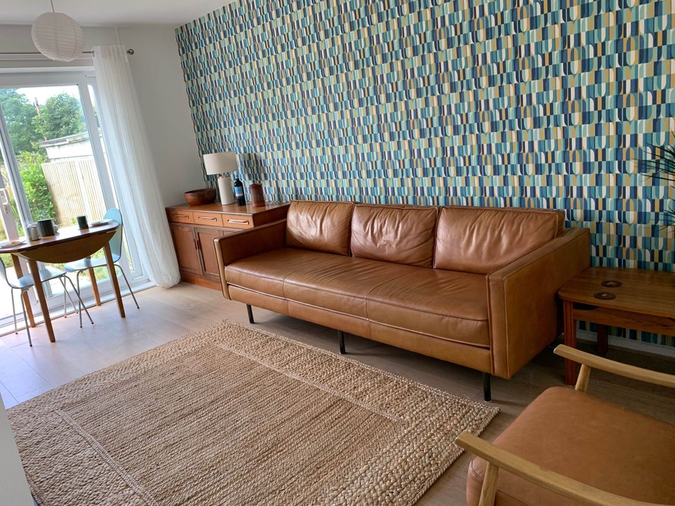 A living room with a sofa and dining table at 2 Bed Sleeps 4 Parking Pets 10 min walk to Beach in Falmouth