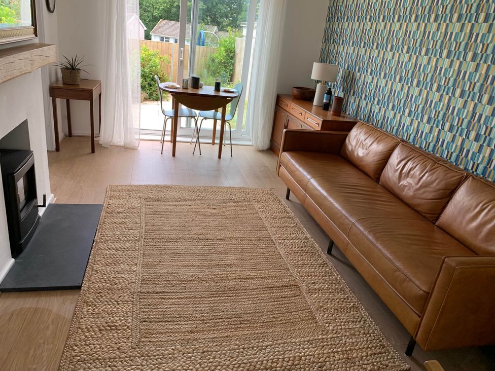 A living room with a sofa, table, and fireplace at 2 Bed Sleeps 4 Parking Pets 10 min walk to Beach, Falmouth