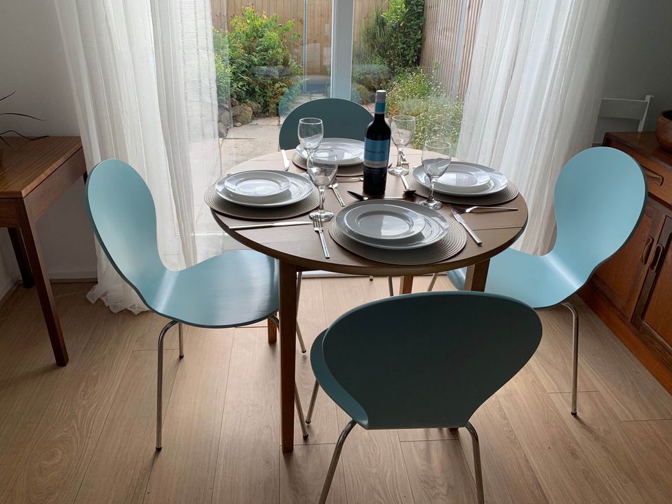 A dining room with a table set for a meal at 2 Bed Sleeps 4 Parking Pets 10 min walk to Beach in Falmouth