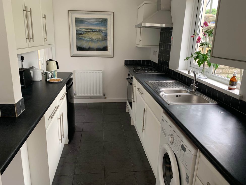 A kitchen with a sink and washing machine at 2 Bed Sleeps 4 Parking Pets 10 min walk to Beach in Falmouth