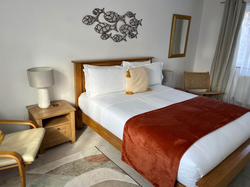 A bedroom with a bed and nightstand at 2 Bed Sleeps 4 Parking Pets 10 min walk to Beach Falmouth