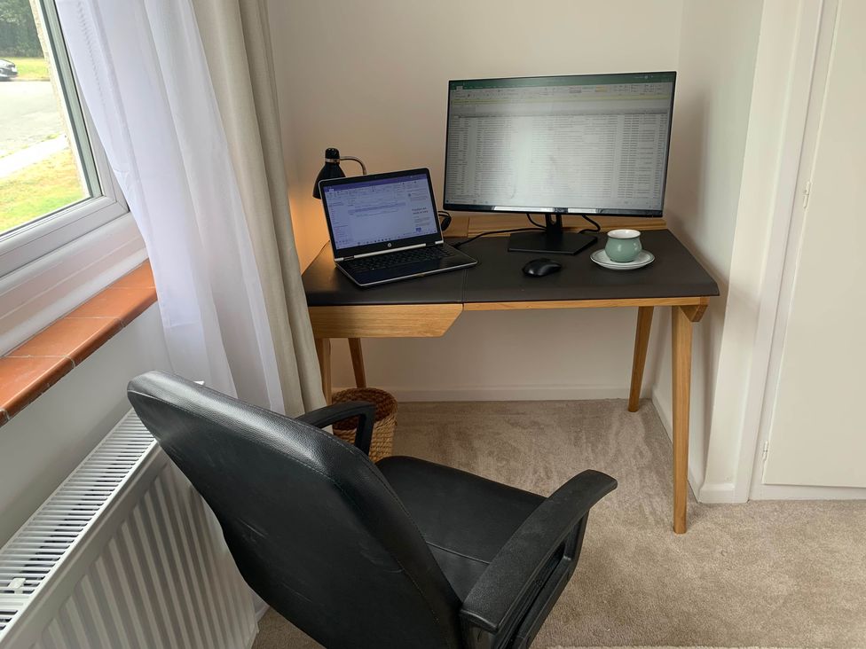 An office setup with a desk, monitor, laptop, and chair at 2 Bed Sleeps 4 Parking Pets 10 min walk to Beach in Falmouth