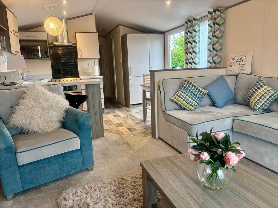 A living room with sofa and dining area at Caravan in Holcot Sleeps 6 Max 6 people Max 4 adults per booking Pet Friendly Holcot near Moulton