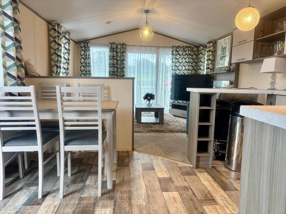 A living room with a dining table and chairs at Caravan in Holcot Sleeps 6 Max 6 people Max 4 adults per booking Pet Friendly Holcot near Moulton