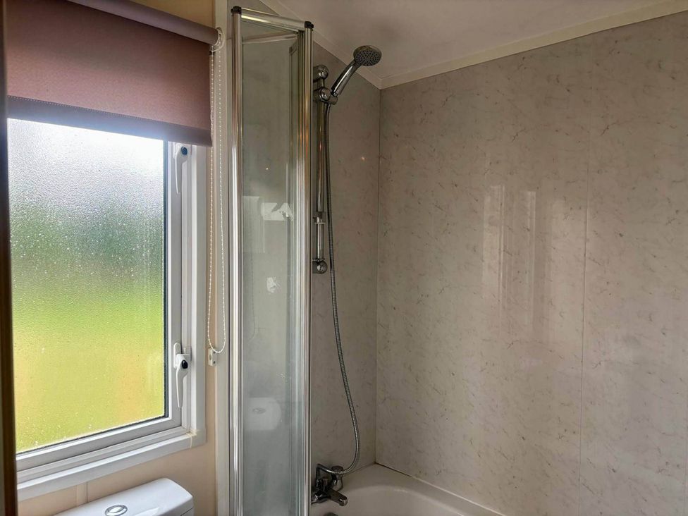 A shower and bathtub in a bathroom at Caravan in Holcot Sleeps 6 Max 6 people Max 4 adults per booking Pet Friendly in Holcot near Moulton