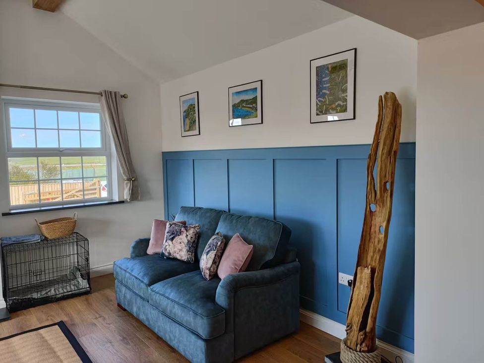 A living room with a sofa and wall art at Aberporth 2 Bed Cottage Sleeps 4 Pet Friendly, Parcllyn near Aberporth