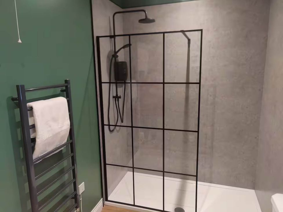 A bathroom with a shower enclosure and towel rack at Aberporth 2 Bed Cottage Sleeps 4 Pet Friendly Parcllyn near Aberporth