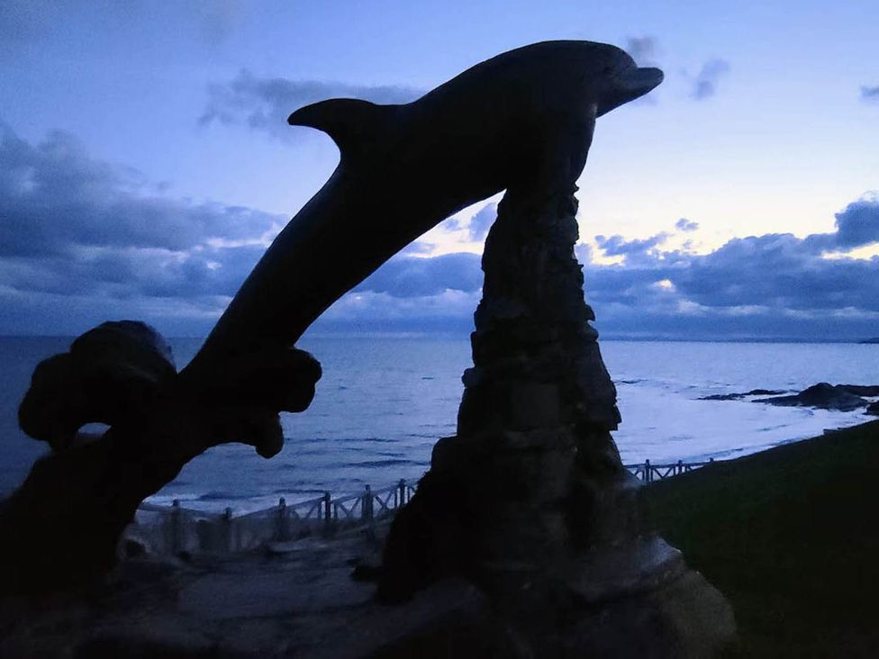 A dolphin statue near the sea at Aberporth 2 Bed Cottage Sleeps 4 Pet Friendly Parcllyn near Aberporth