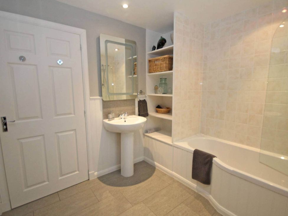 A bathroom with a sink and bathtub at Findochty Beach house Private Garden BeachFront in Findochty