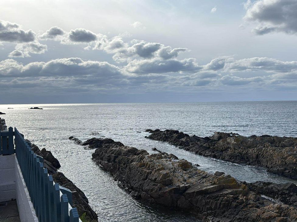 A view of the ocean and rocks at Findochty Beach house Private Garden BeachFront, Findochty