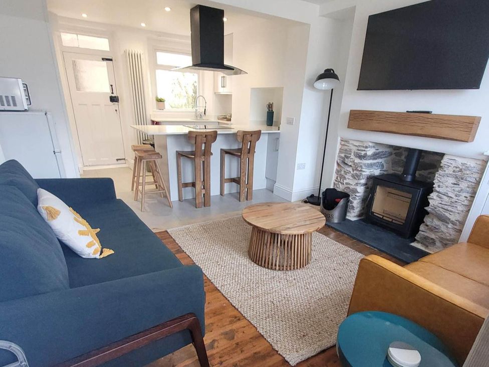 A living room with a sofa and coffee table at Looe Cottage Seaside views log fire sleeps 4 in Looe