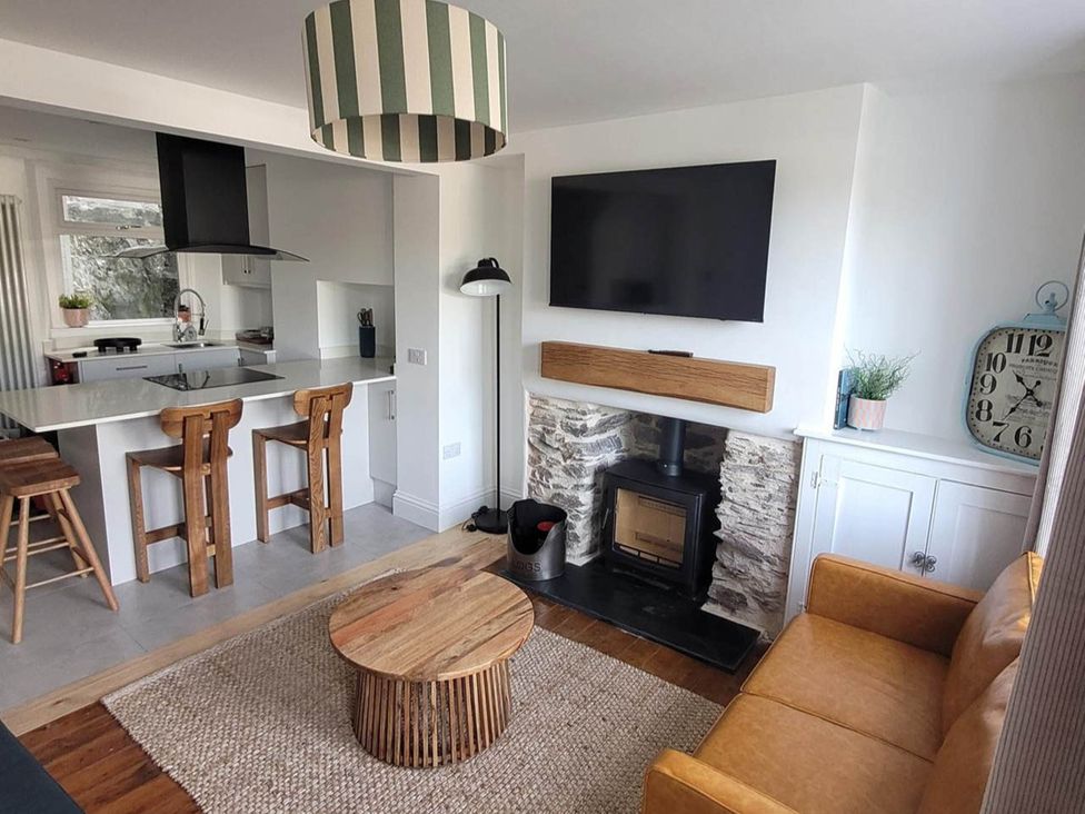 A living room with a sofa and coffee table at Looe Cottage Seaside views log fire sleeps 4 in Looe