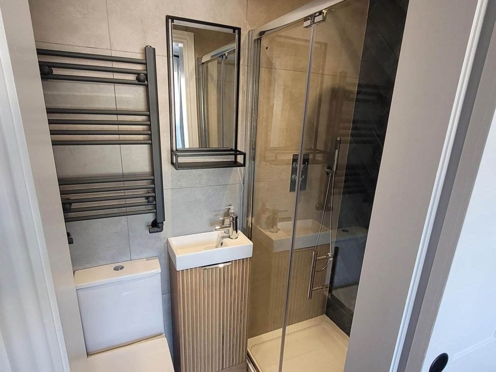 A bathroom with a shower, sink and toilet at Looe Cottage Seaside views log fire sleeps 4 in Looe