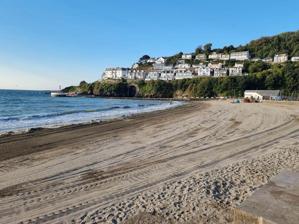 A beach with houses on a hillside at Looe Cottage Seaside views log fire sleeps 4 in Looe