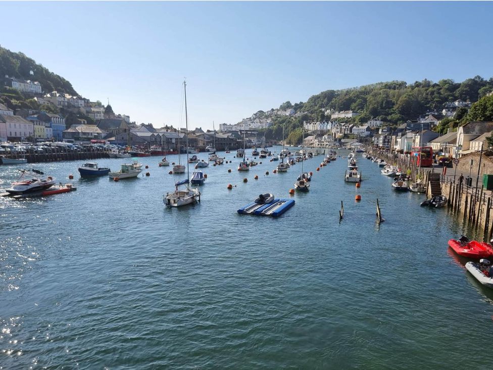 A waterway with boats and buildings at Looe Cottage Seaside views log fire sleeps 4 Looe