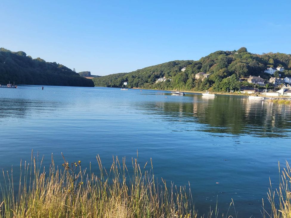 A lake with boats and hills at Looe Cottage Seaside views log fire sleeps 4 Looe