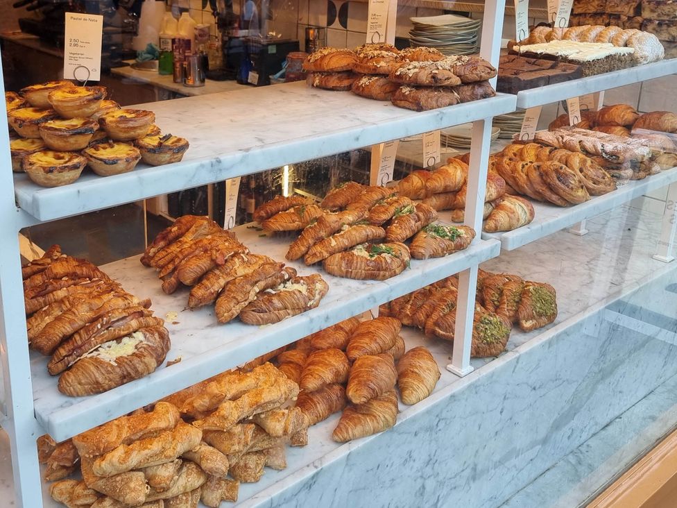 A display of pastries and croissants at a bakery