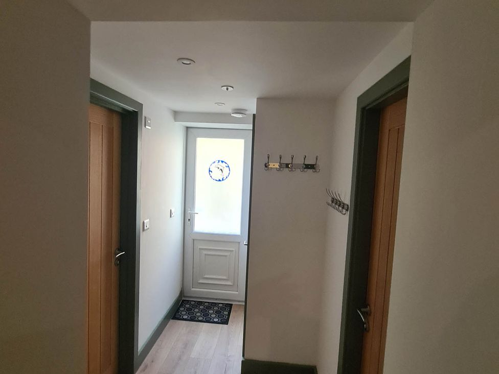 A hallway with coat hooks and a door at Conwy Charm Cottage 3 Bed Retreat in Penmaenmawr