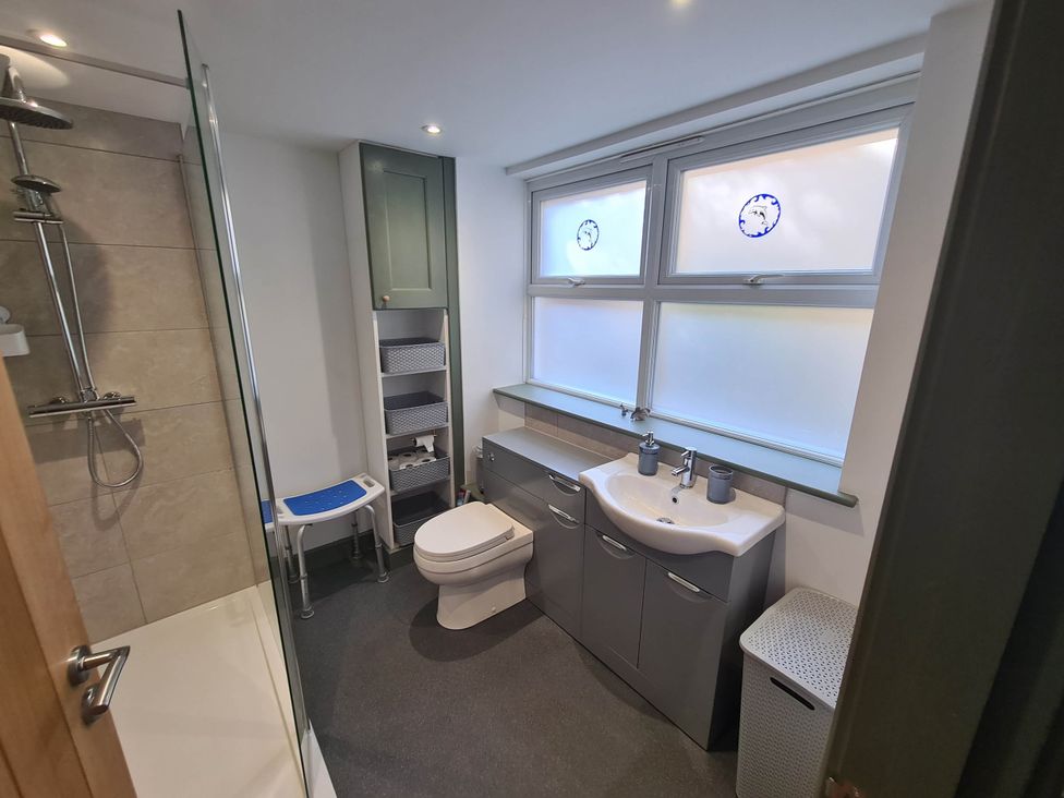 A bathroom with a shower, toilet, and sink at Conwy Charm Cottage 3 Bed Retreat in Penmaenmawr