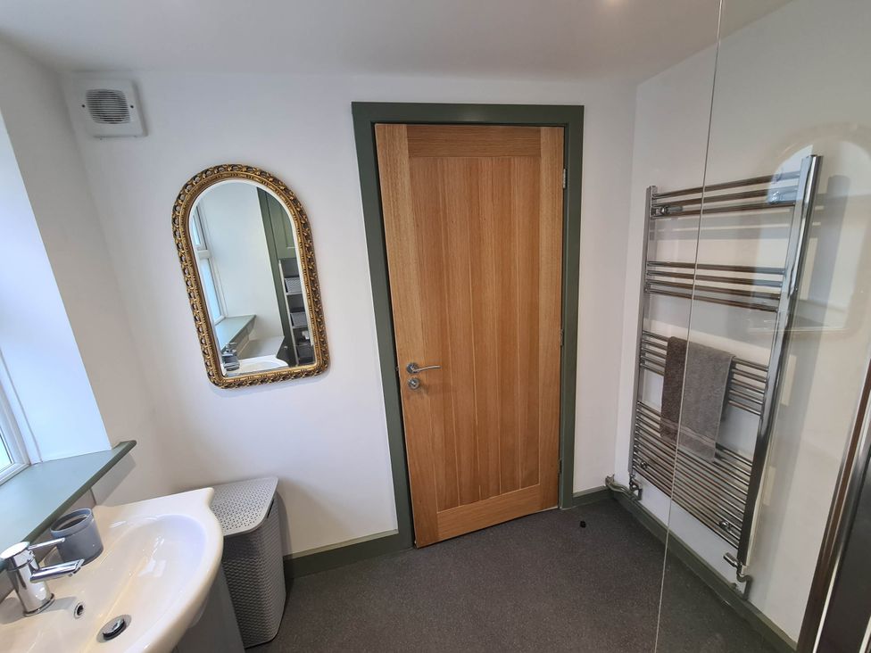 A bathroom with a sink and mirror at Conwy Charm Cottage 3 Bed Retreat in Penmaenmawr