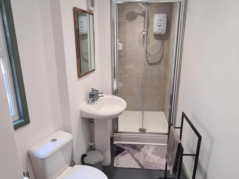 A bathroom with a sink, toilet, and shower at Conwy Charm Cottage 3 Bed Retreat Penmaenmawr